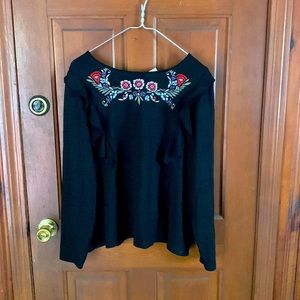 Black lightweight sweater with floral detail and ruffles on the side
